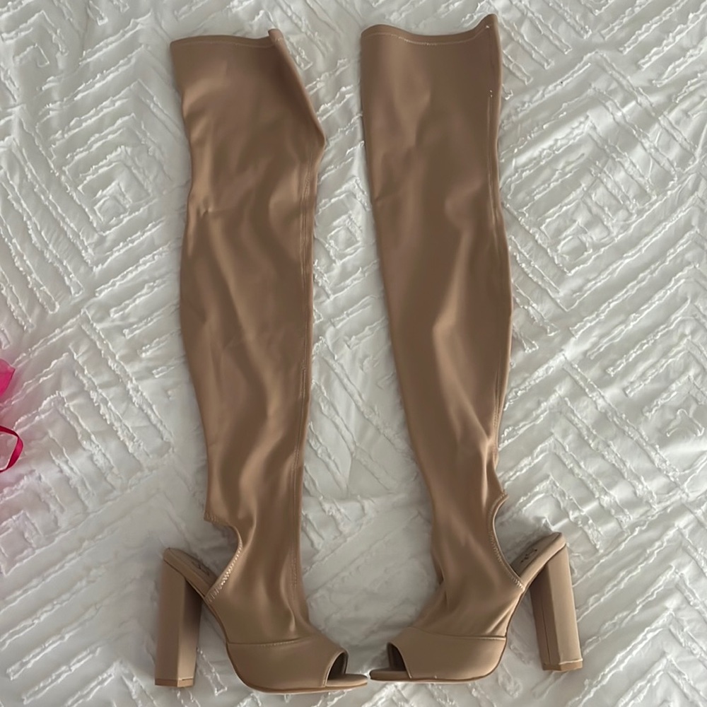 Never been worn over the knee open toe heels. Comes in a mesh bag.